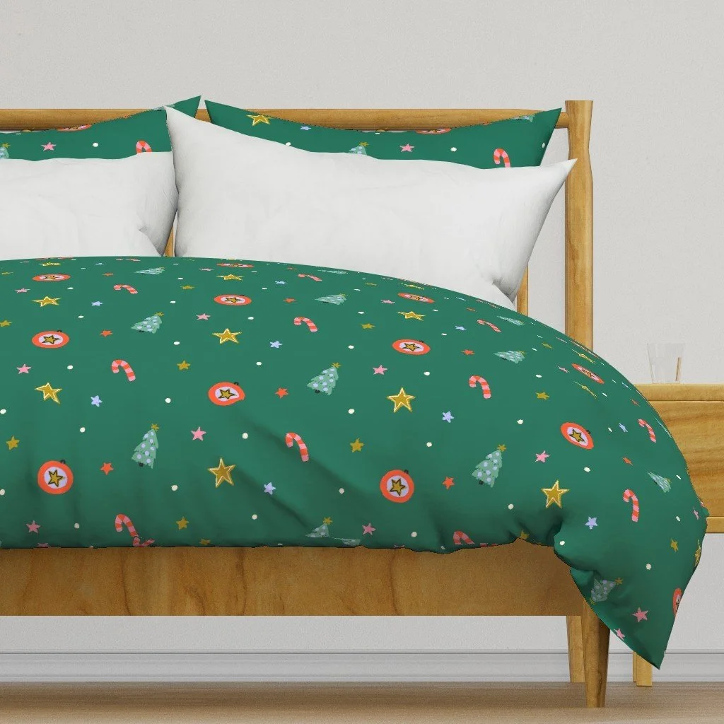 Jolly & Bright: Ditsy Christmas Toss with Candy Canes and Stars on Emerald on a duvet cover by Spoonflower, copyright Sandra Hutter.