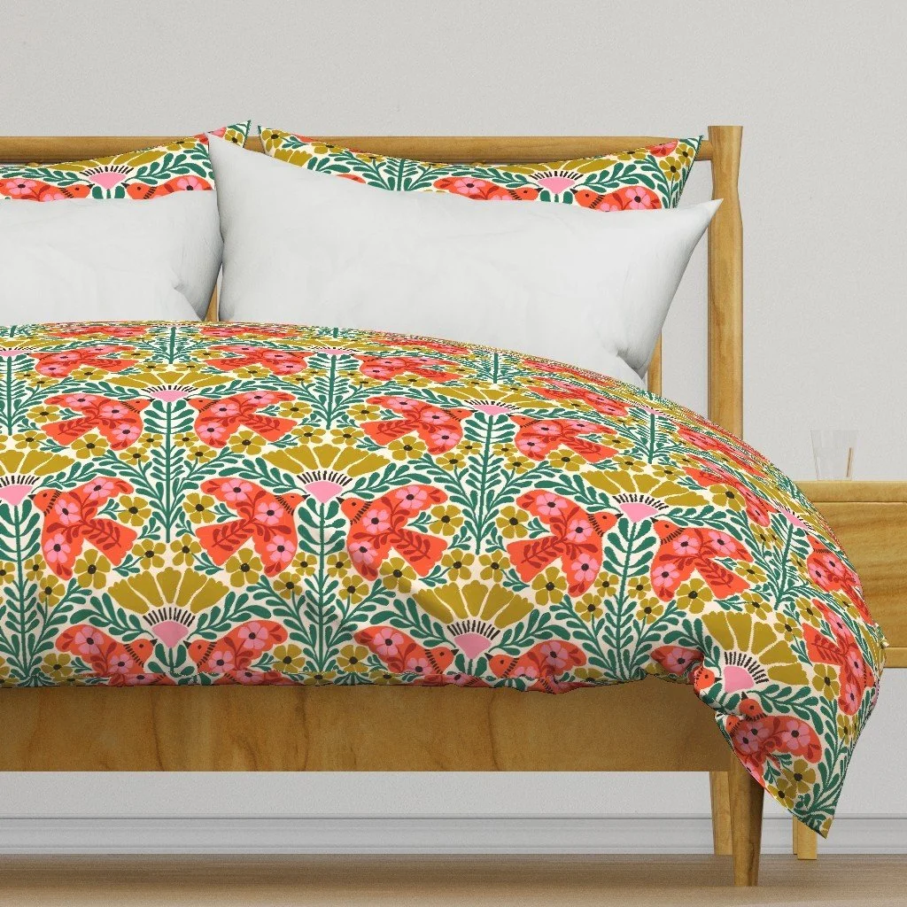 Bedroom with a Jolly & Bright duvet cover by Sandra Hutter: folk Christmas birds and flowers in red, mustard, pink and emerald on cream
