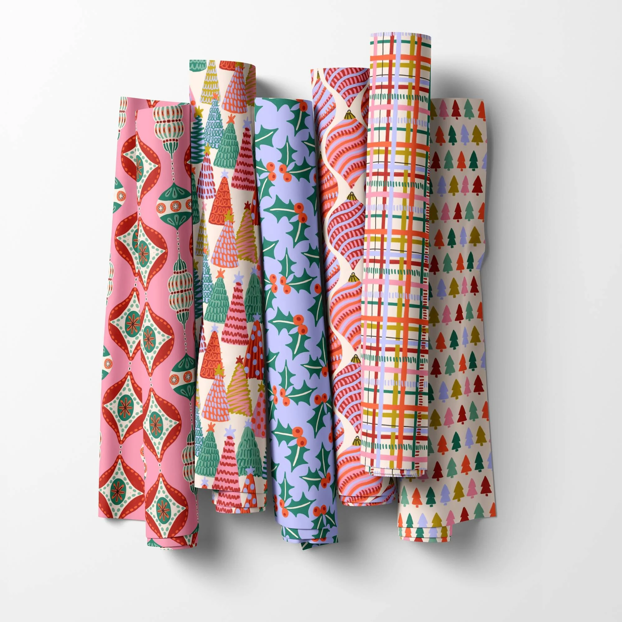 Jolly & Bright Christmas fabric rolls by Sandra Hutter with ornaments, Christmas trees, holly, plaid and tree rows in pink, emerald and lavender