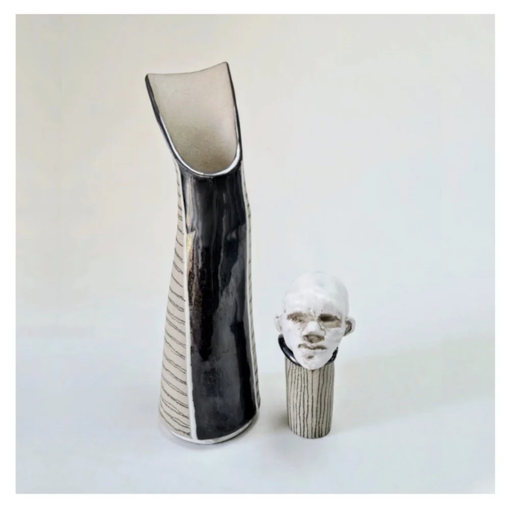Vase with freestanding sculpted head stopper