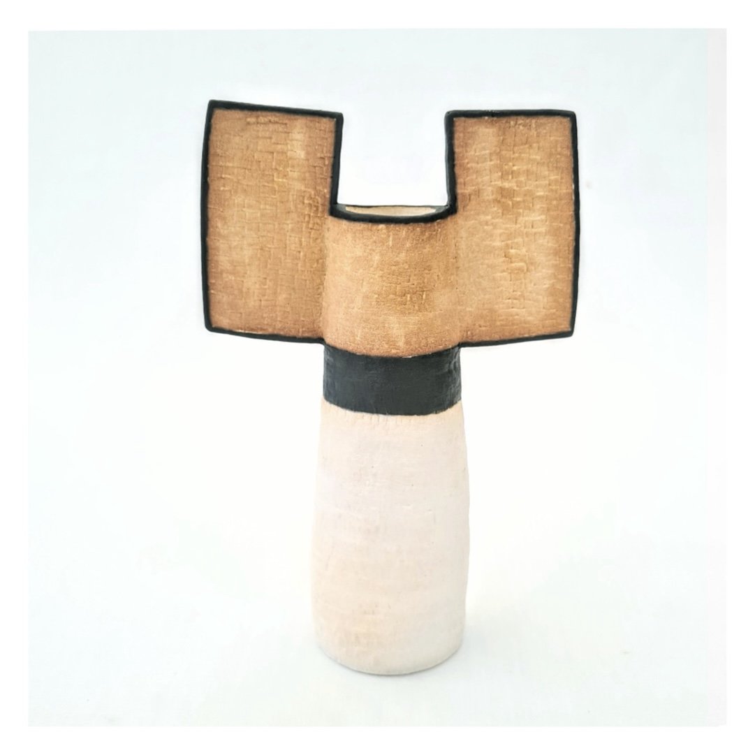 Small winged ceramic vase detailed in white, black and tan
