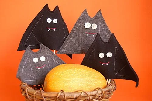 four bat finger puppets in grey and black