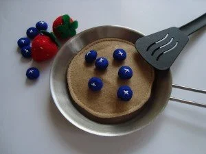 felt pancakes with blueberries served on metal pan