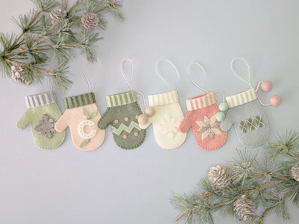 six mini felt mittens in pastel colours