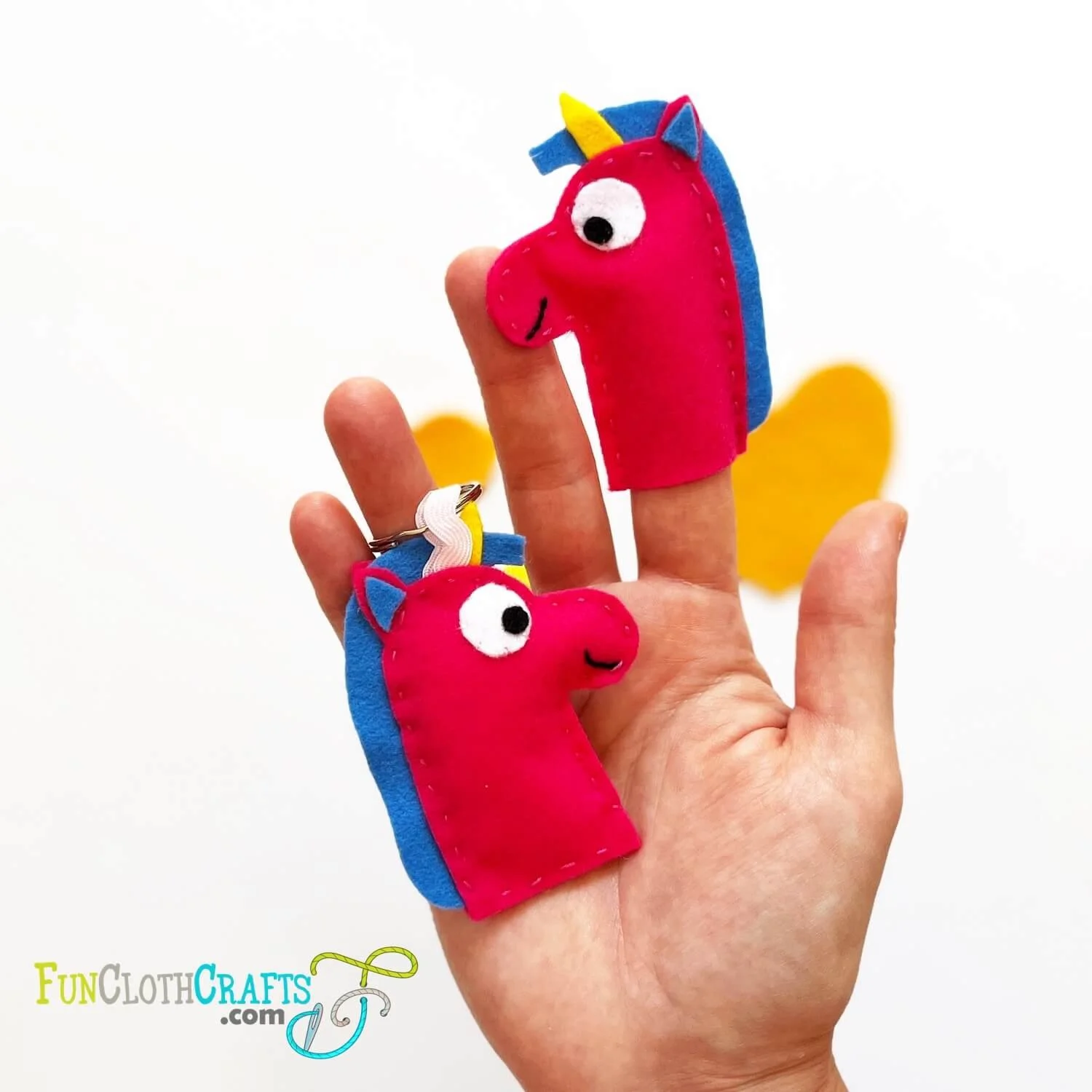 unicorn finger puppet and unicorn felt keychain on hand