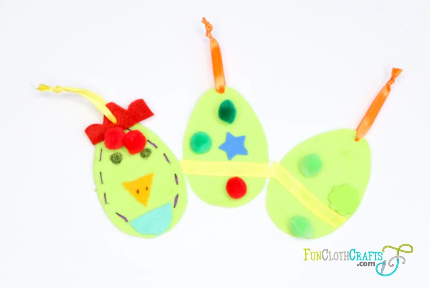 three green felt easter eggs with decoration made by kids