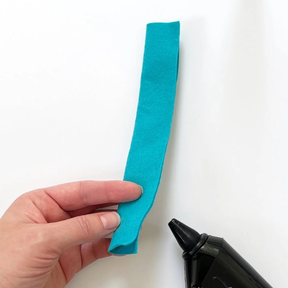 felt stripe folded in half and glued to make rolled felt flower