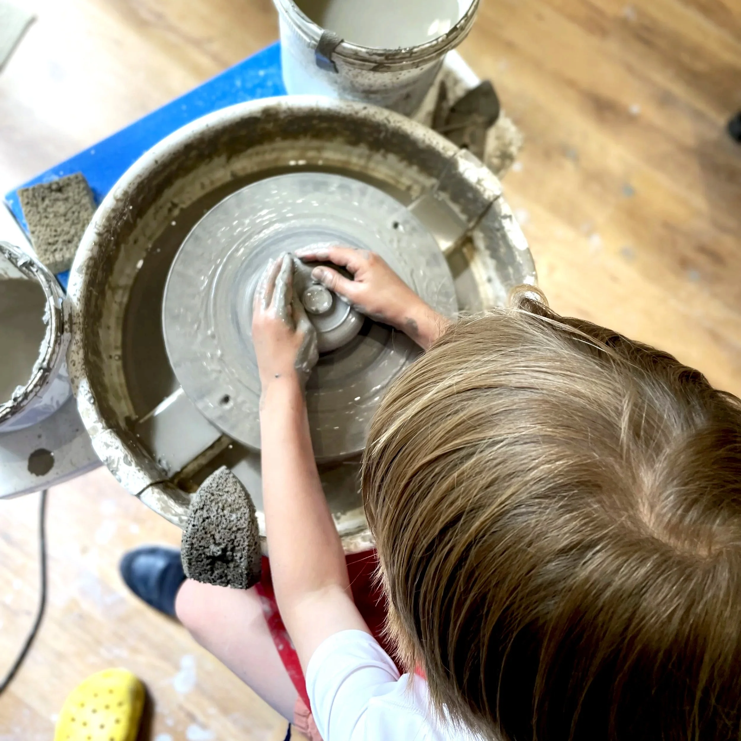Childrens throwing lesson on the wheel