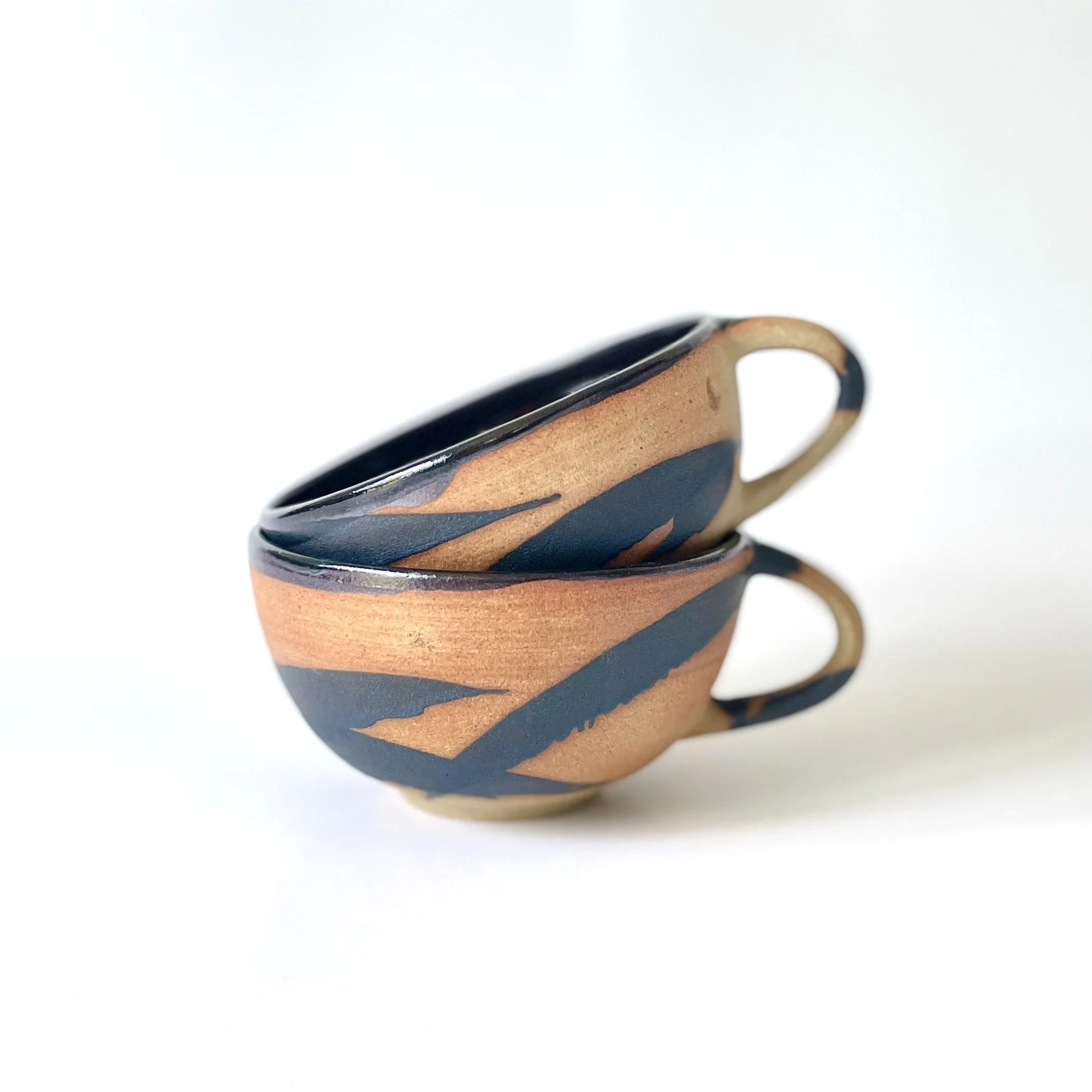 Hand thrown stoneware cups glazed in tenmoku and charcoal mark making 1