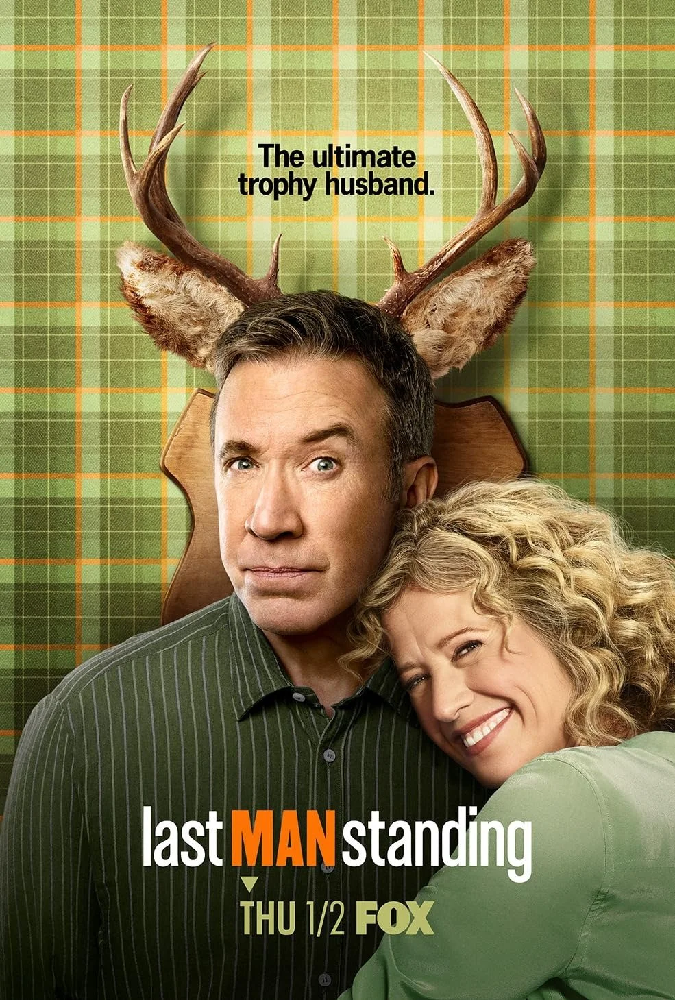 Poster for the TV show 'Last Man Standing' featuring a man with dark hair and a woman with curly blonde hair embracing him, with antlers and ears on his head, and a green plaid background. The text reads 'The ultimate trophy husband.' and 'THU 1/2 FO