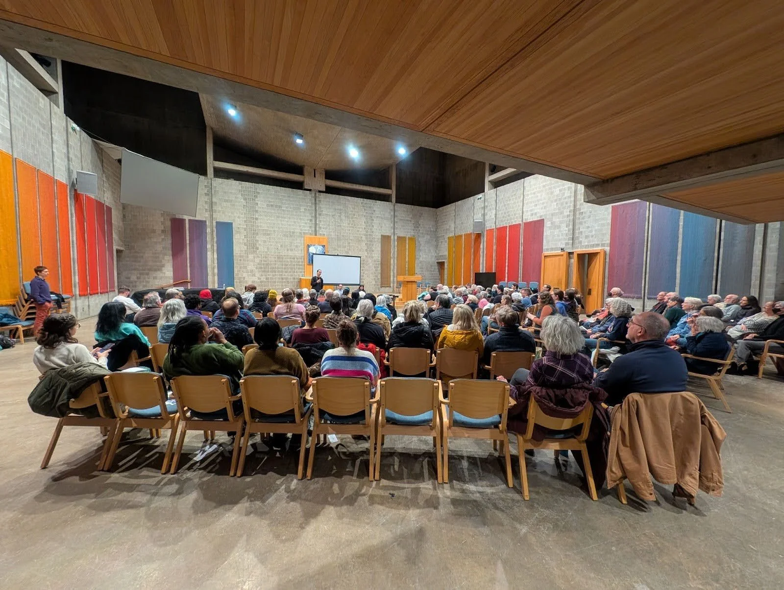 Monroe County community members at a screening of “Unheard Voices,” February 2025. Grandell Logan addresses the audience.