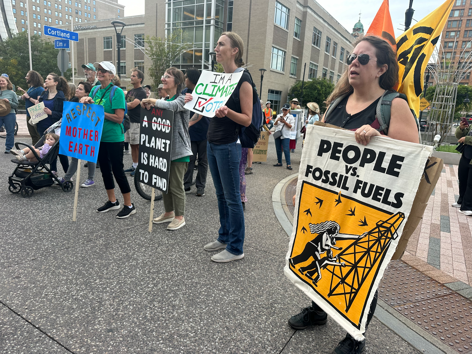Community members holding signs at the Rochester Climate March, Sept 2024