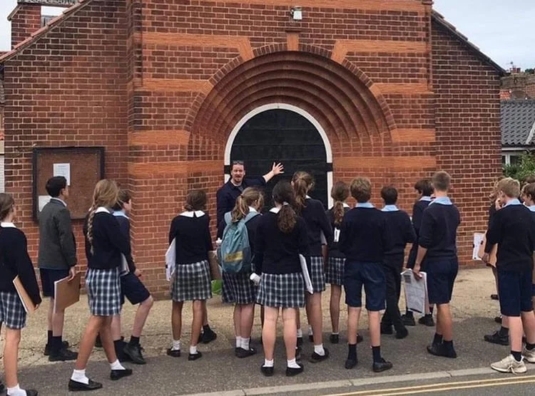 Photograph of schoolchildren being introduced to Norfolk architecture