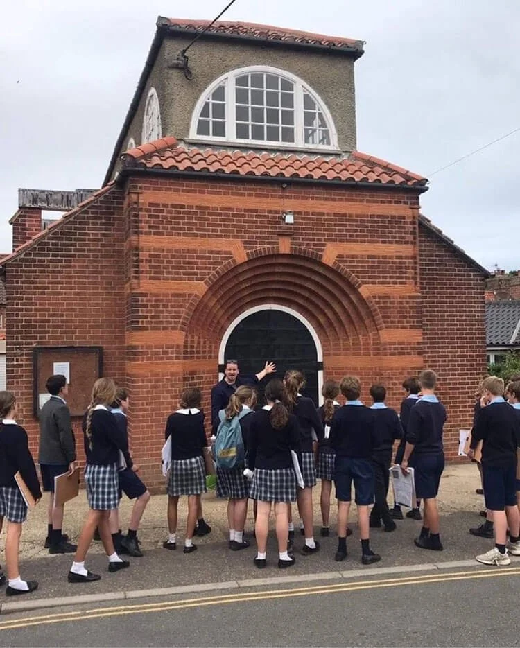 Photograph of Edde showing Norfolk schoolchildren the architecture of Edwin Lutyens