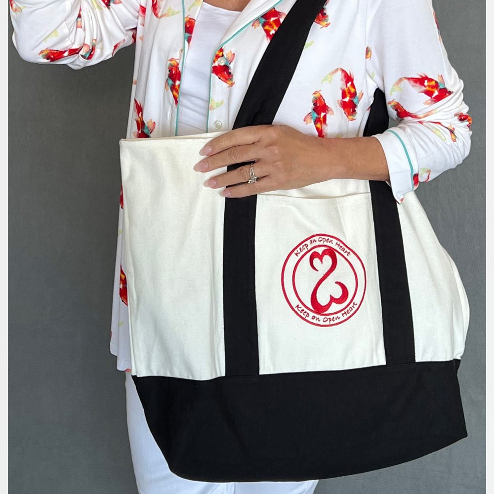 SIGNATURE TOTE Inspired by Jane’s signature “Open Heart” philosophy, featuring a wealth of uses all women will instantly appreciate.