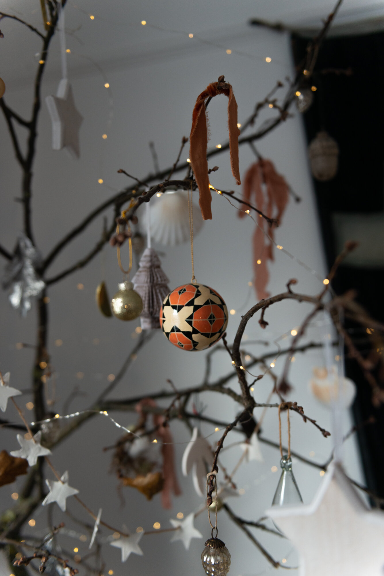  Our Christmas branch! An alternative eco-friendly zero-cost Christmas tree idea. The orange and white Toast baubles are made from recycled paper. Ribbon is by The Natural Dye Works. The brass moon decoratins are by Workshop ltd.  