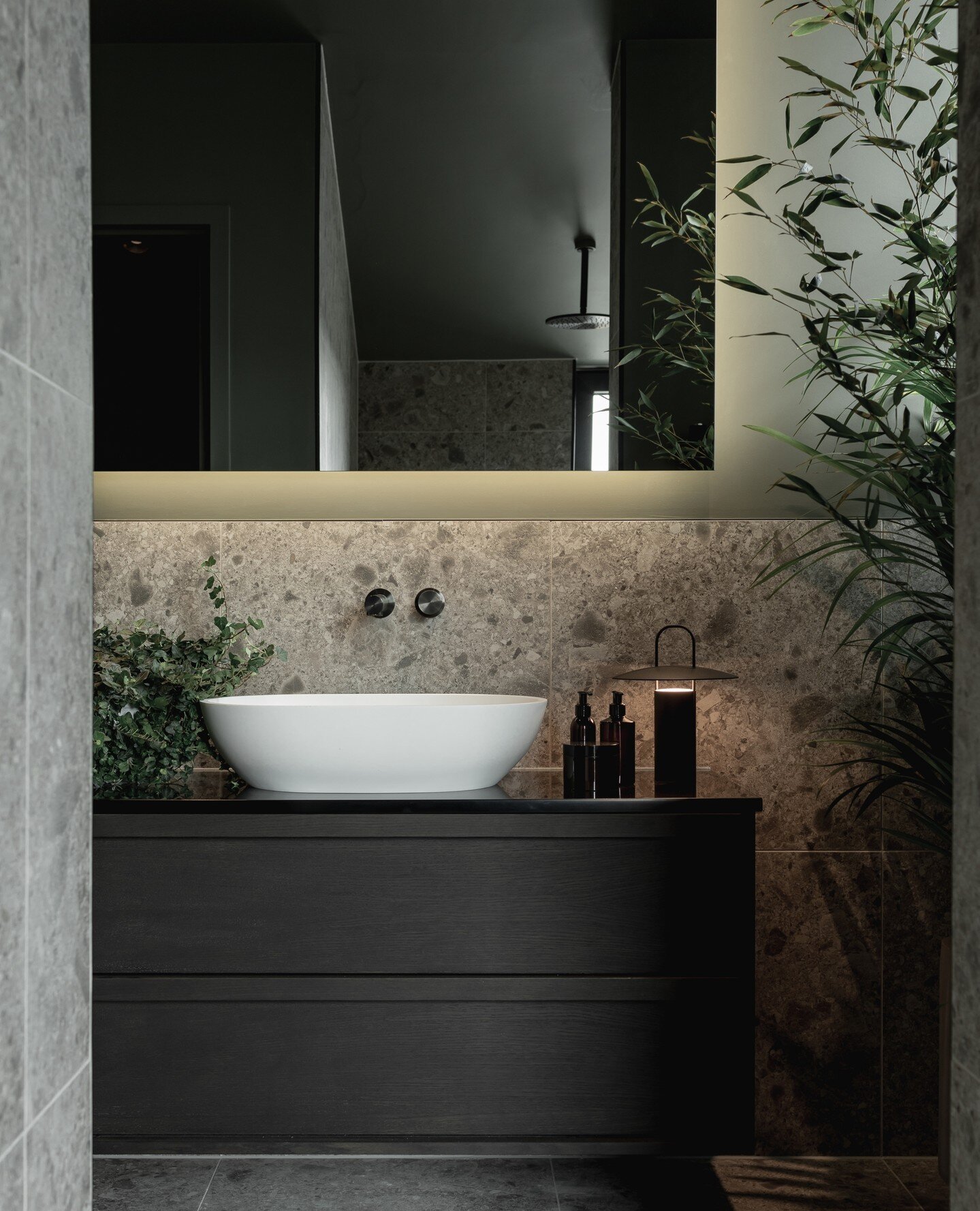 In matte white, the Picasso stone countertop basin provides a beautiful contrast to the dark hues and earthy tones seen in this luxury bath suite at Koto House.