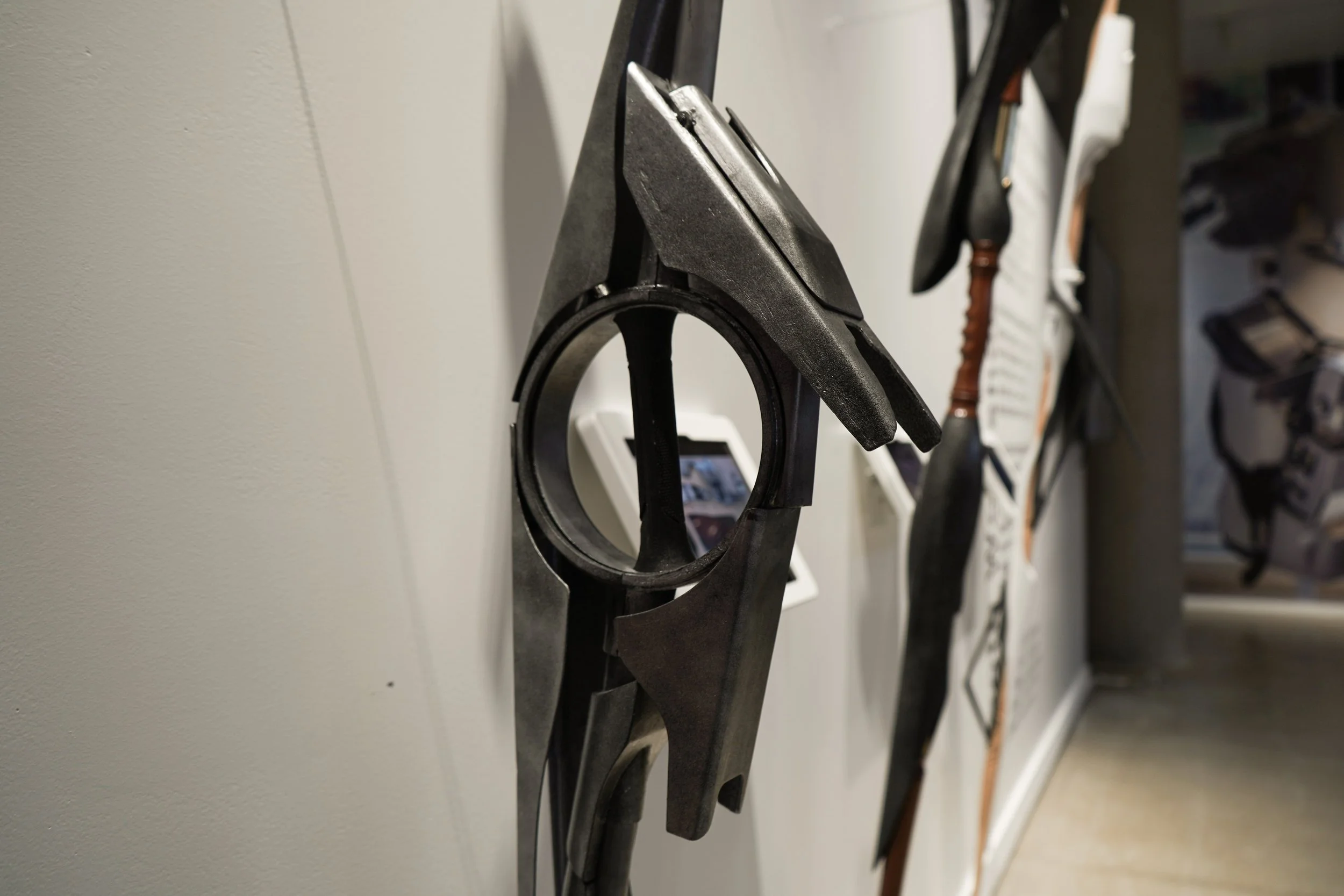 Close up of student's walking stick in dark metal gray with circular design as the handle