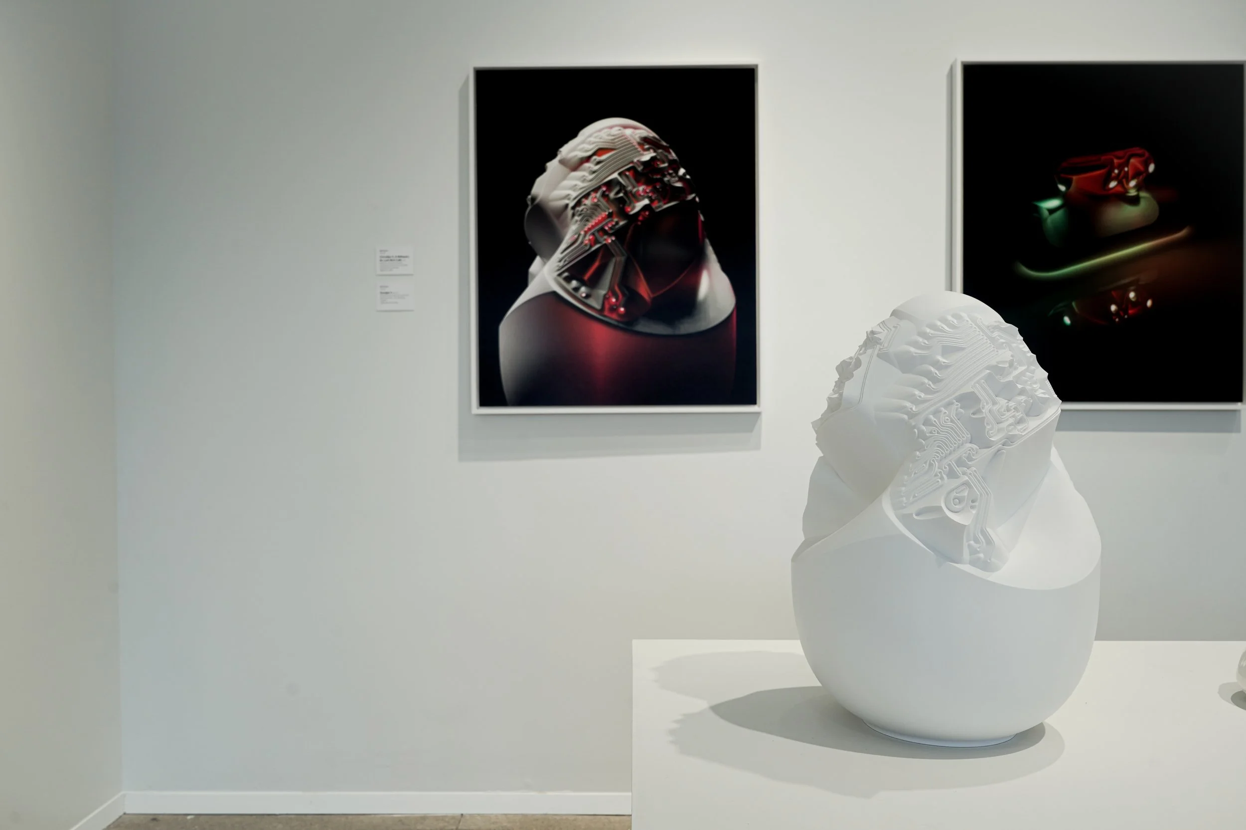 Ceramicology exhibit showing white sculpture on table with the same project in a print on the wall