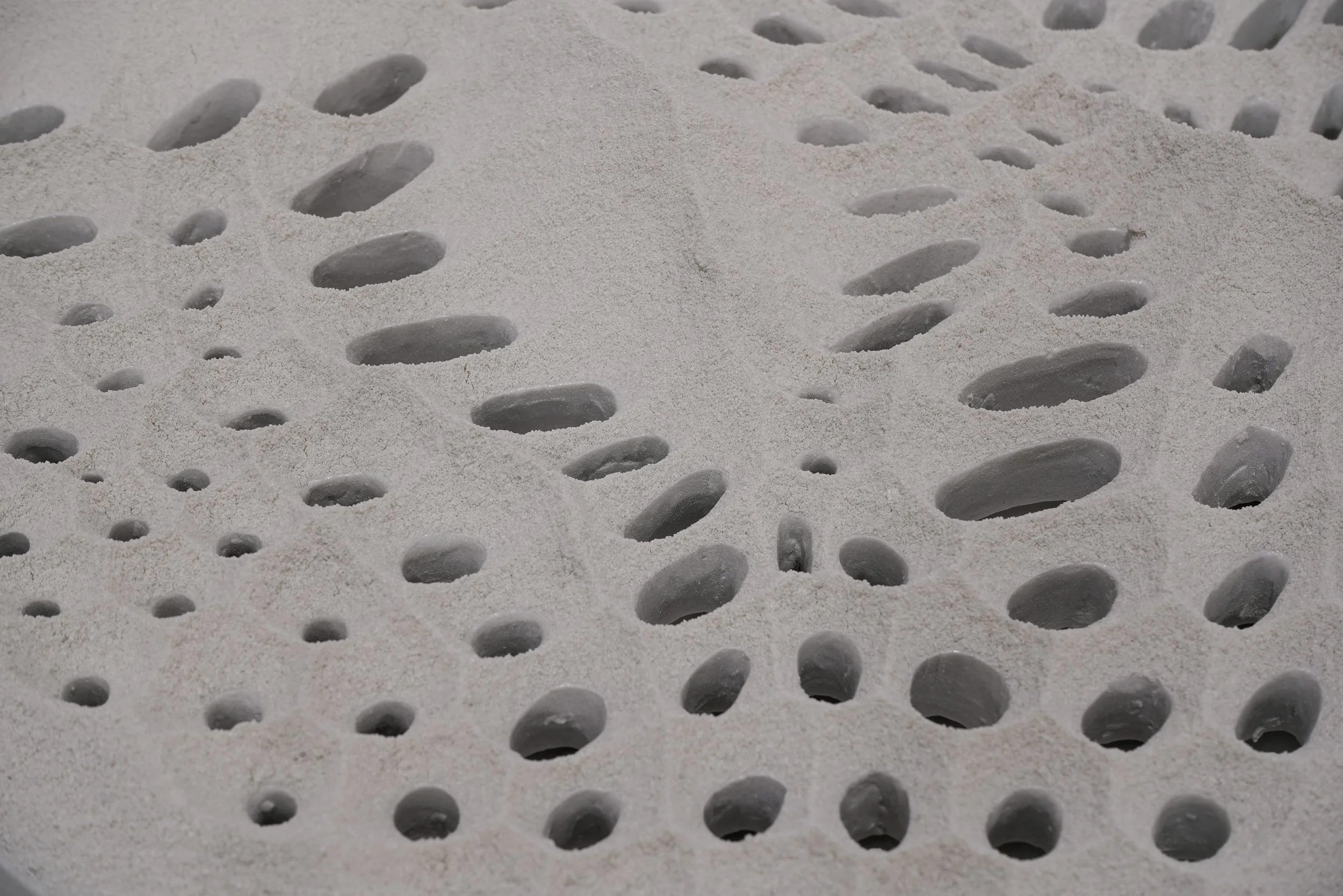 Close up of white sculpture with holes