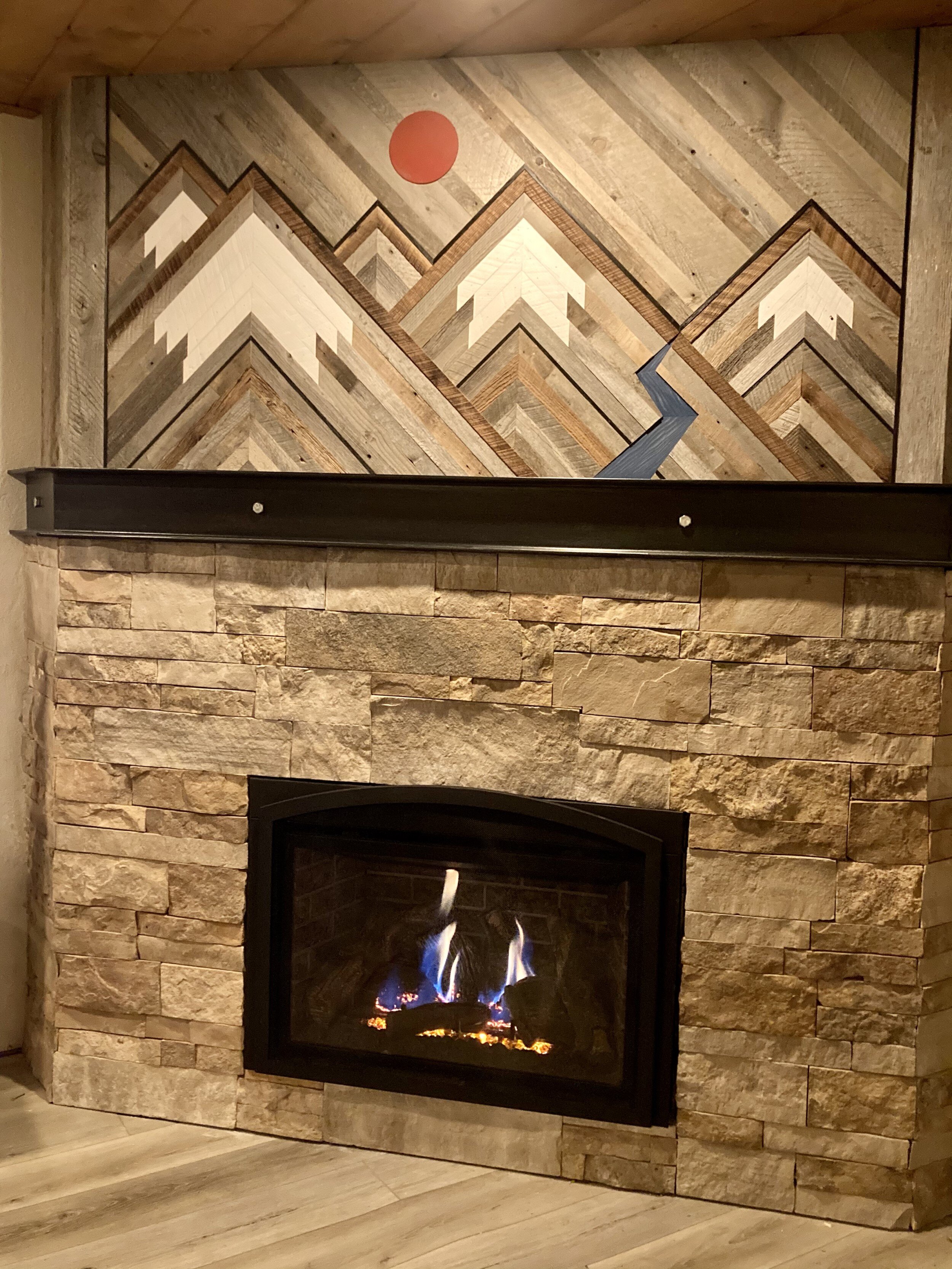 Custom barn wood art work above fireplace