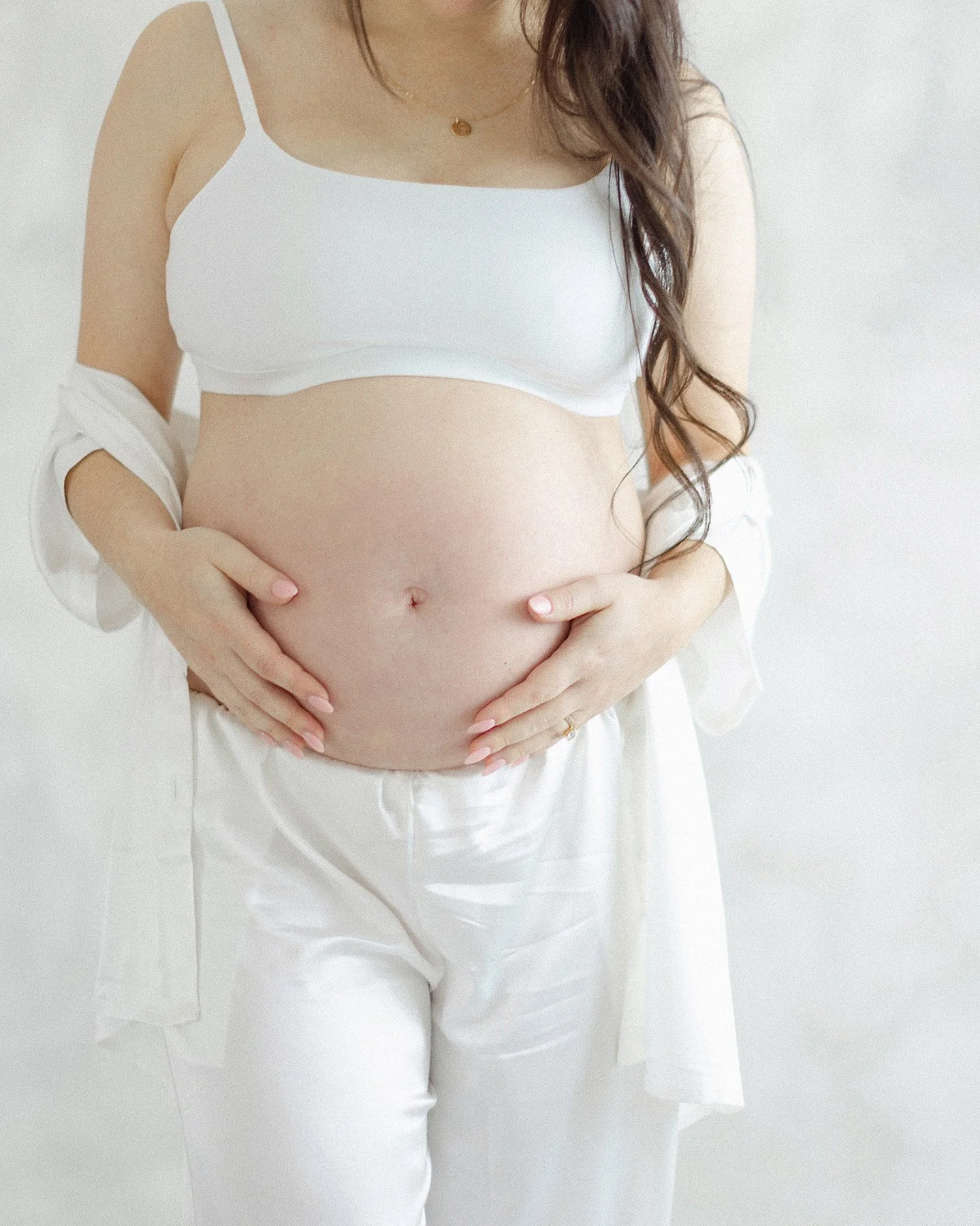 maternity portrait in silk pajamas draped loosely