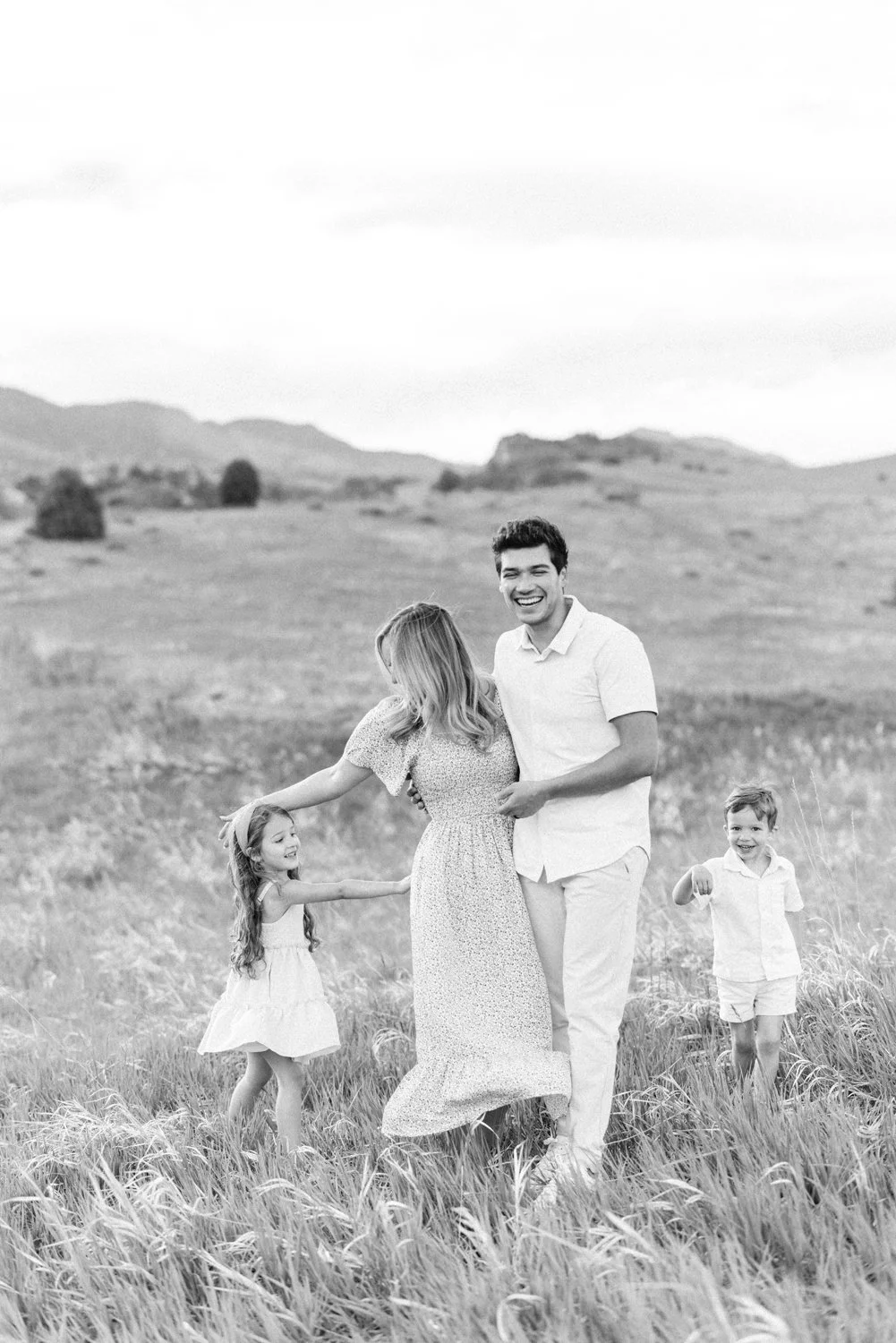 Family playing together in an open field near Denver, Colorado