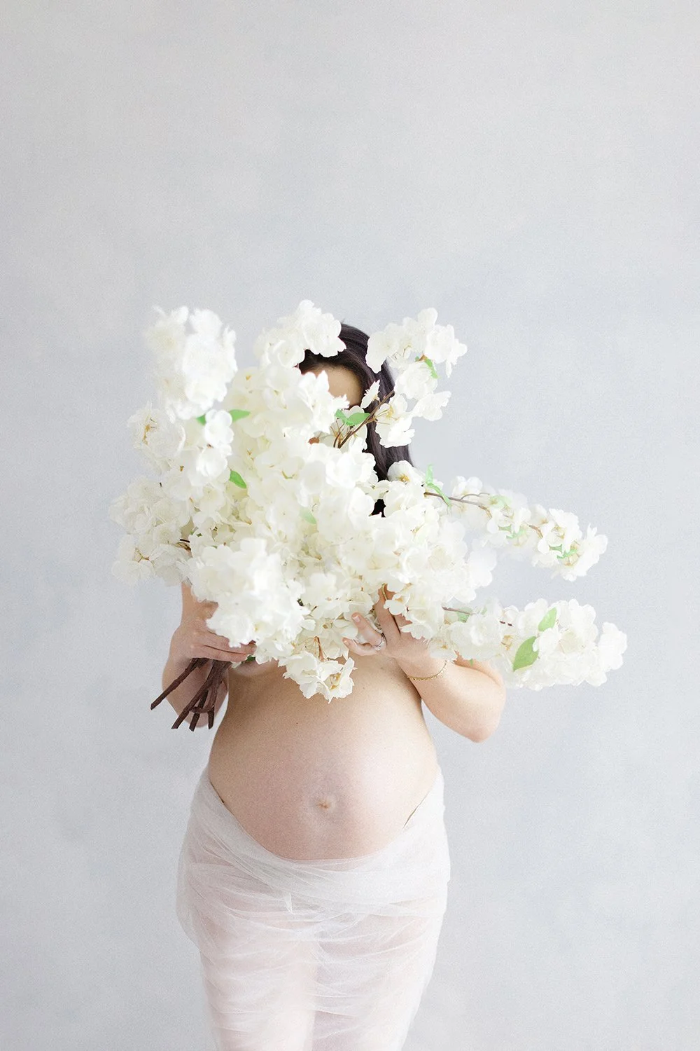 pregnant mom holding large bouquet of flowers