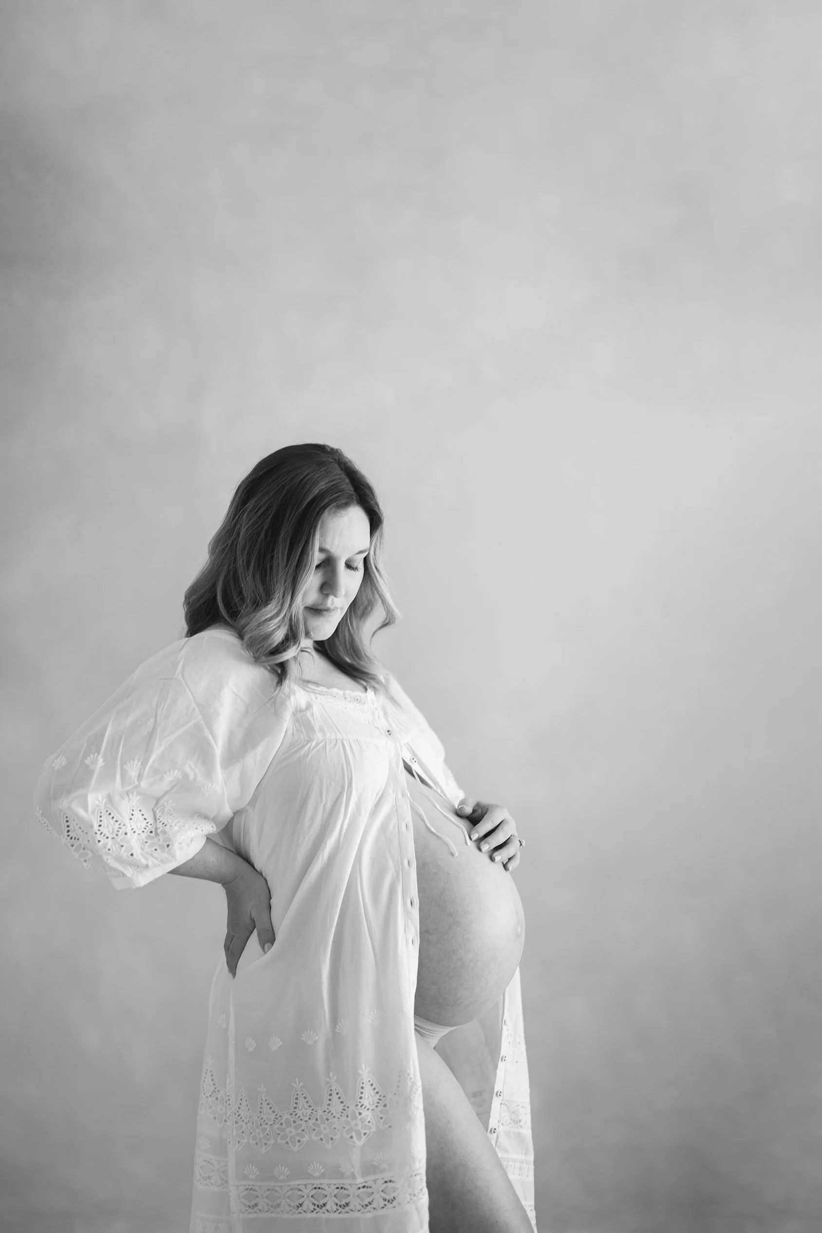 black and white maternity photo in motherhood gown