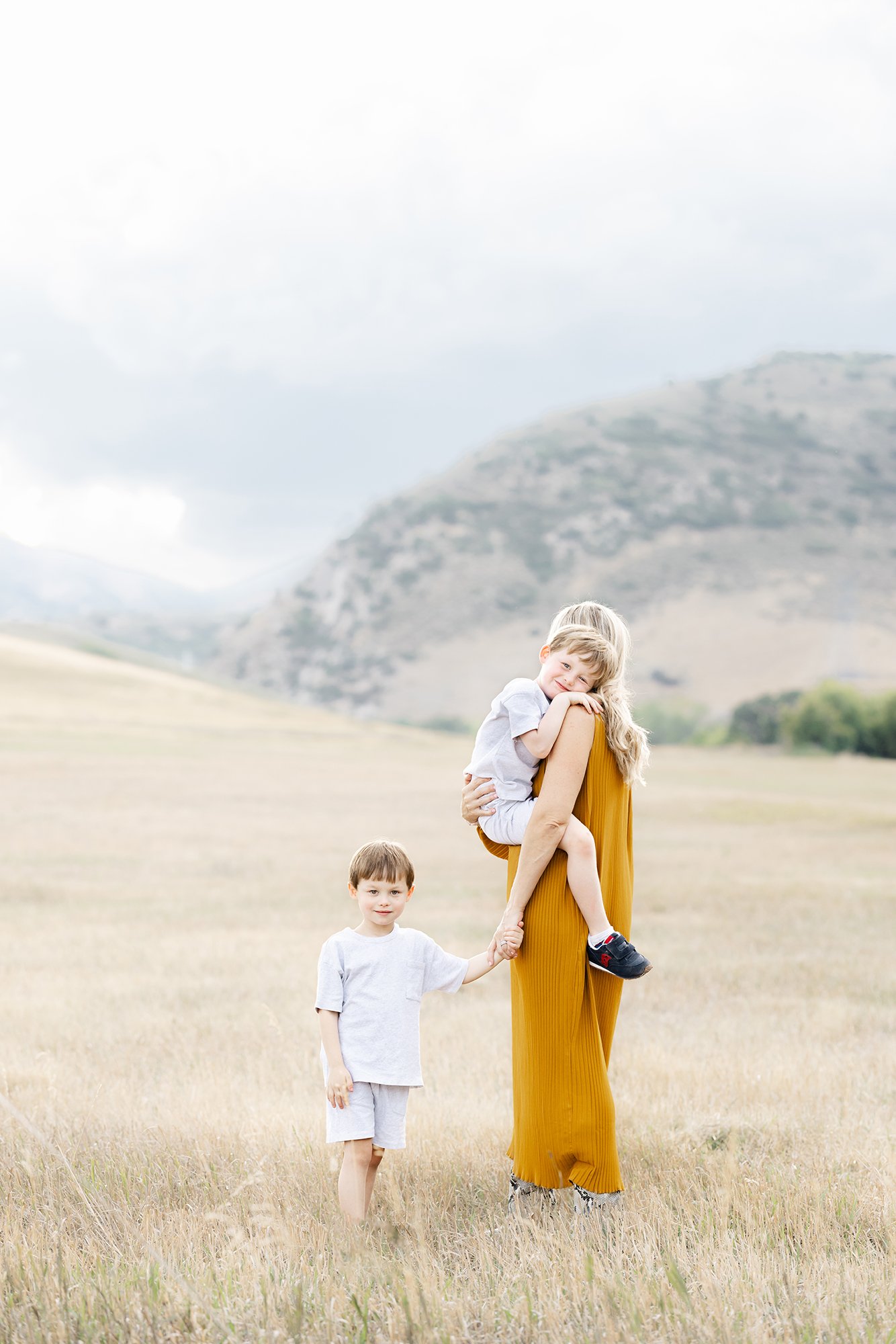 Mother with her two young children during a family portrait session in the Colorado foothills