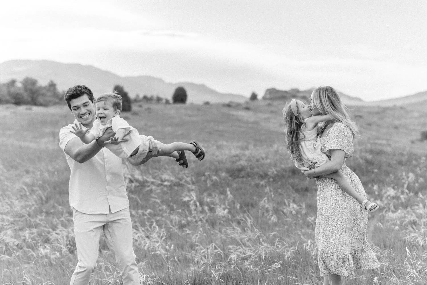 Parents playing with young children in the mountains of Colorado