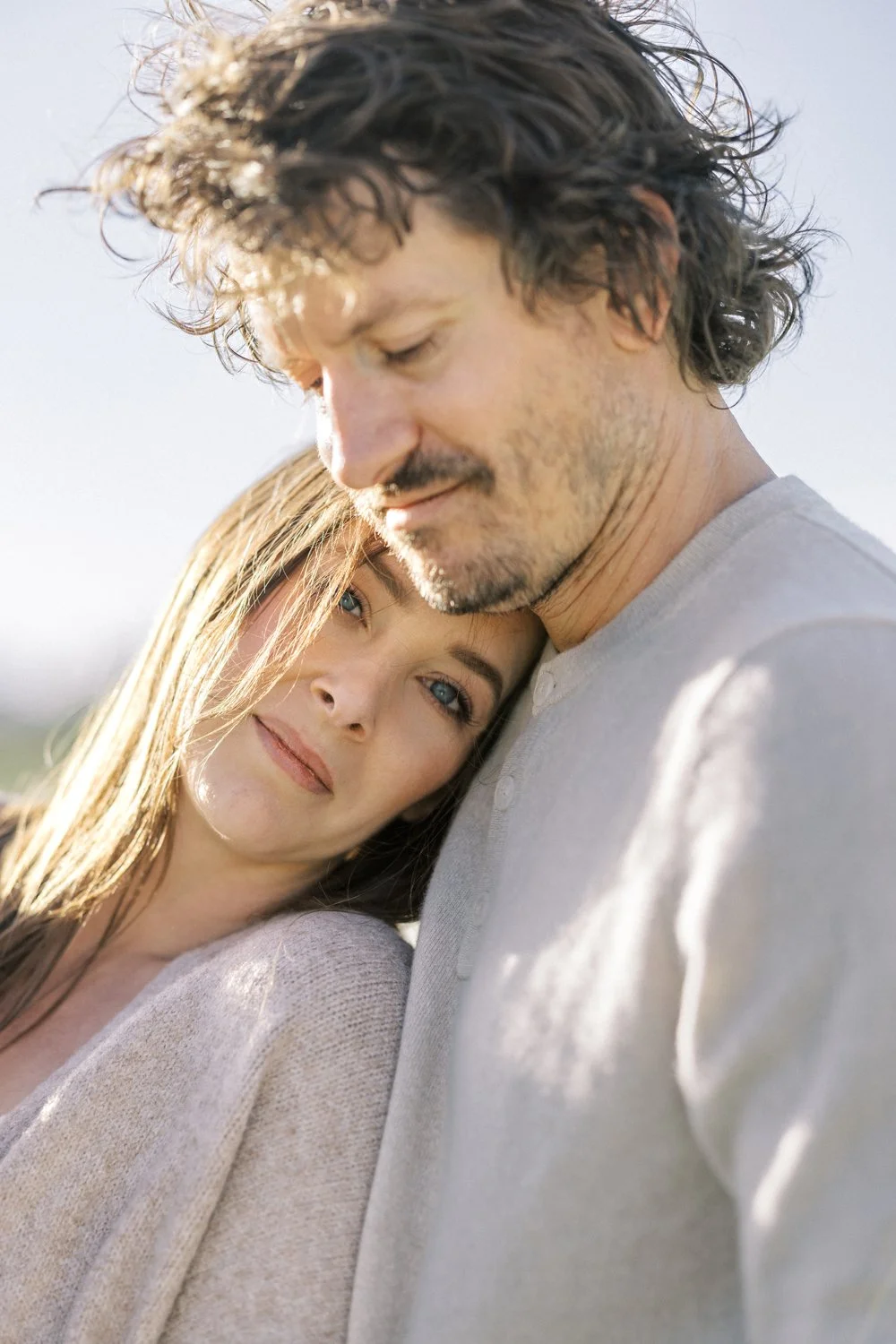 Father holding his wife close during an outdoor family portrait session in Colorado.