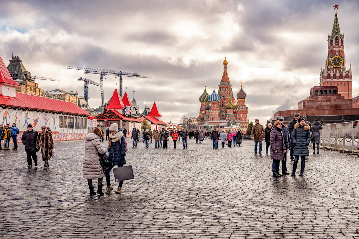 Red Square in Moscow, Russia, with holiday market and traditional landmarks.