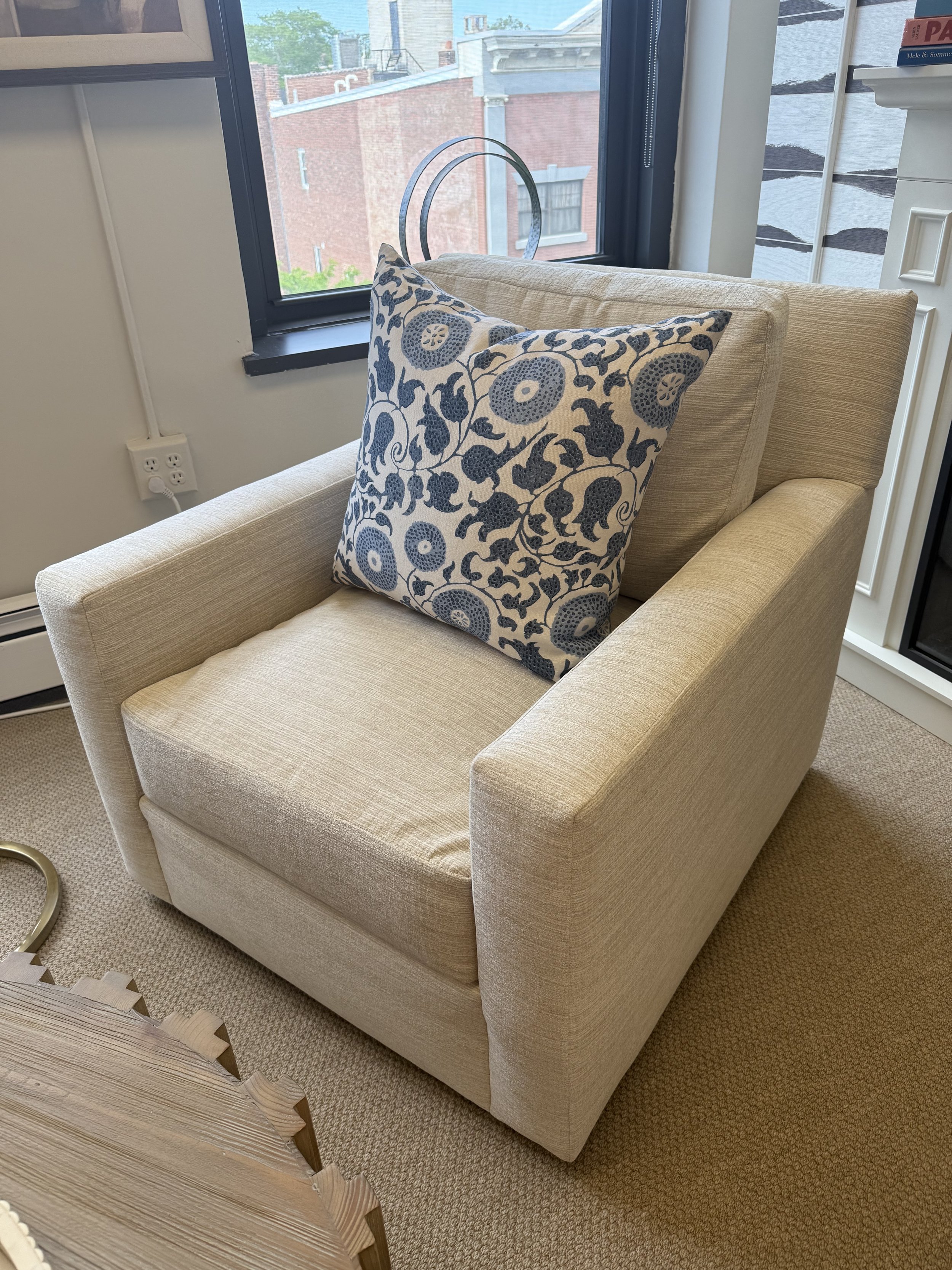 Club Lounger Swivel Chair with neutral textured fabric and blue floral accent pillow (Not included), available at Donna Donaldson Interiors.
