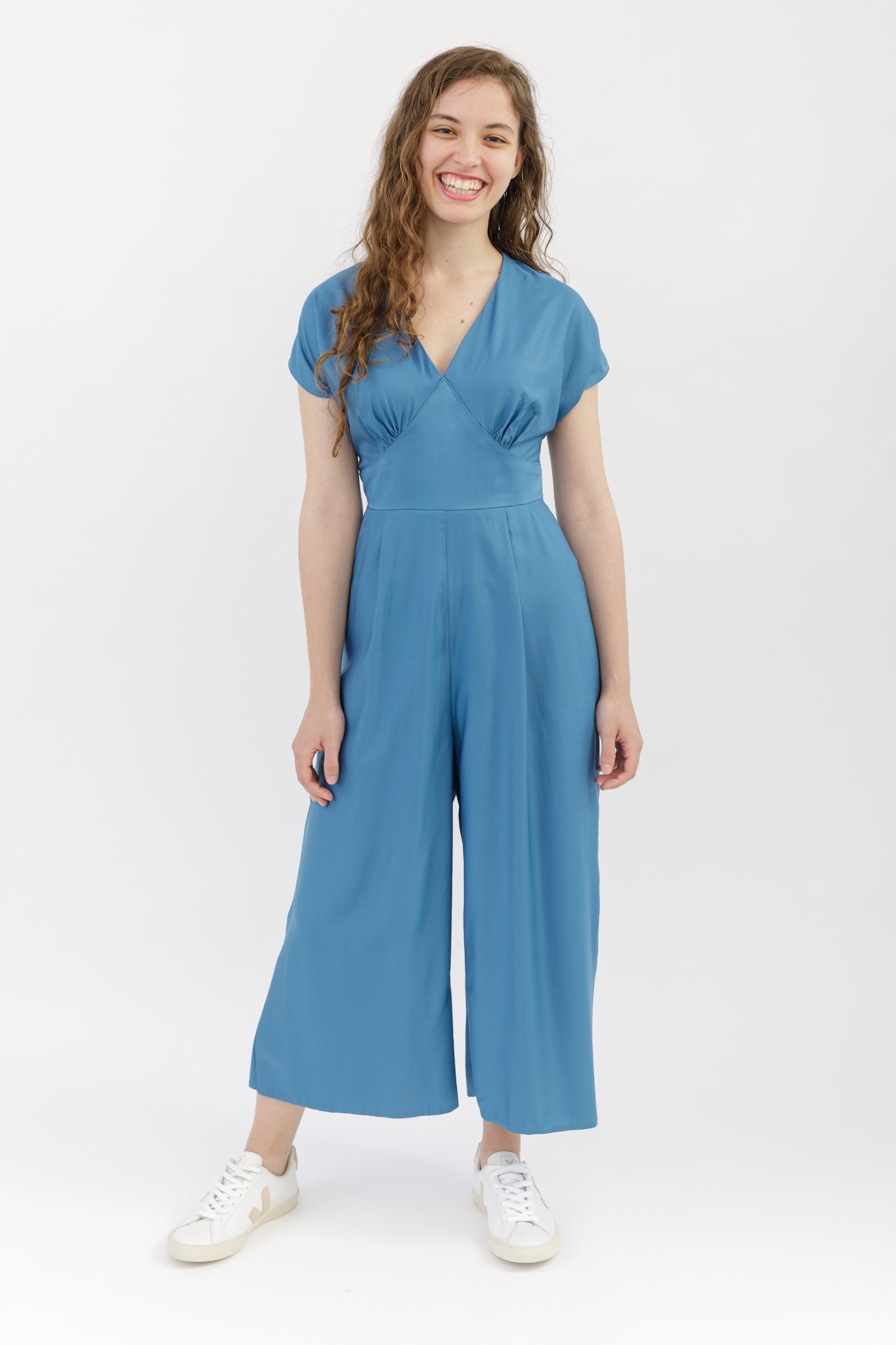 Springe Jumpsuit Pdf Sewing Pattern. Wide leg jumpsuit sewing pattern, with cropped trousers, cap sleeves and a v-neck bodice. Sewn in blue bamboo silk.