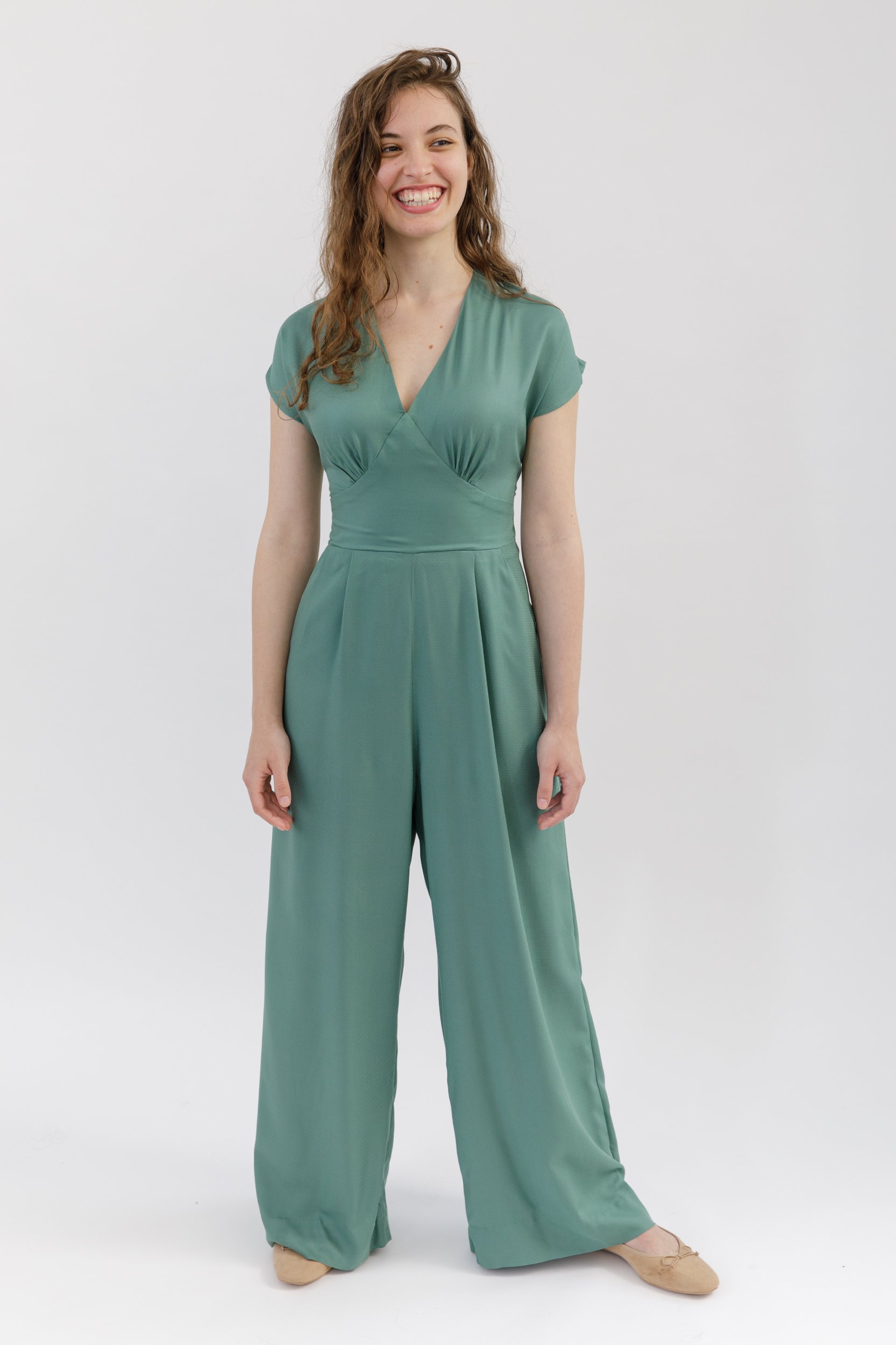 Springe Jumpsuit Pdf Sewing Pattern. Wide leg jumpsuit sewing pattern, with cap sleeves and a v-neck bodice. Sewn in green viscose.