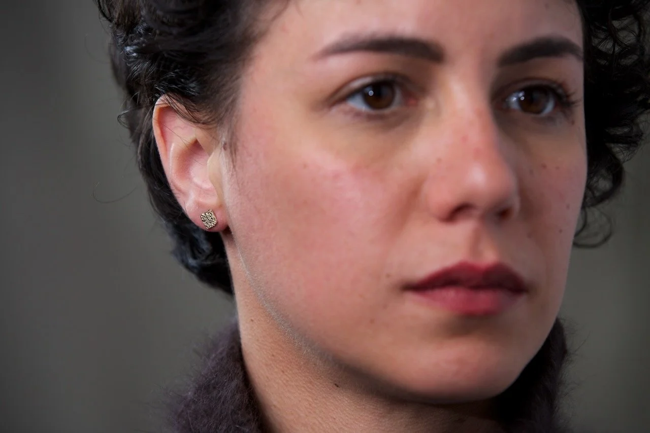 close-up-of-models-face-focusing-on-the-right-ear-wearing-square-stamped-stud-earrings.jpeg