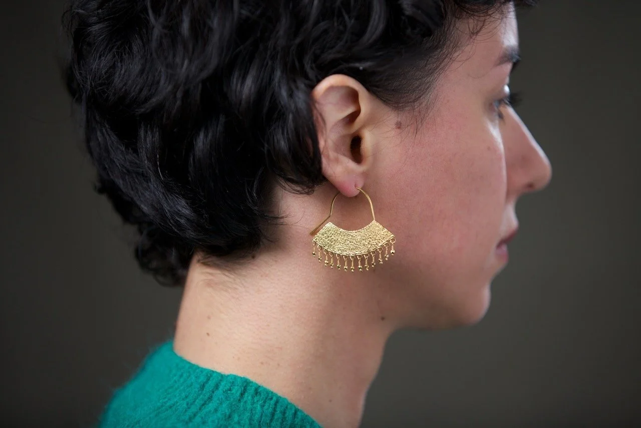 side-shot-of-model-wearing-large-gold-chandelier-earrings.jpeg