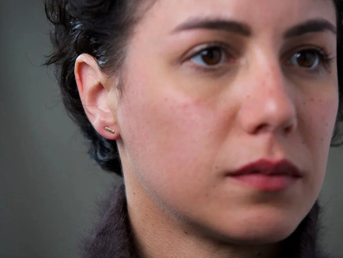close-up-of-models-face-focusing-on-the-right-ear-wearing-long-line-stamped-stud-earrings.jpg
