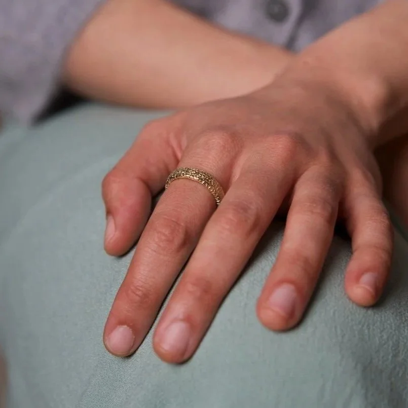 close-up-hand-wearing-mim-best-oval-textured-ring-14ct-gold.jpg