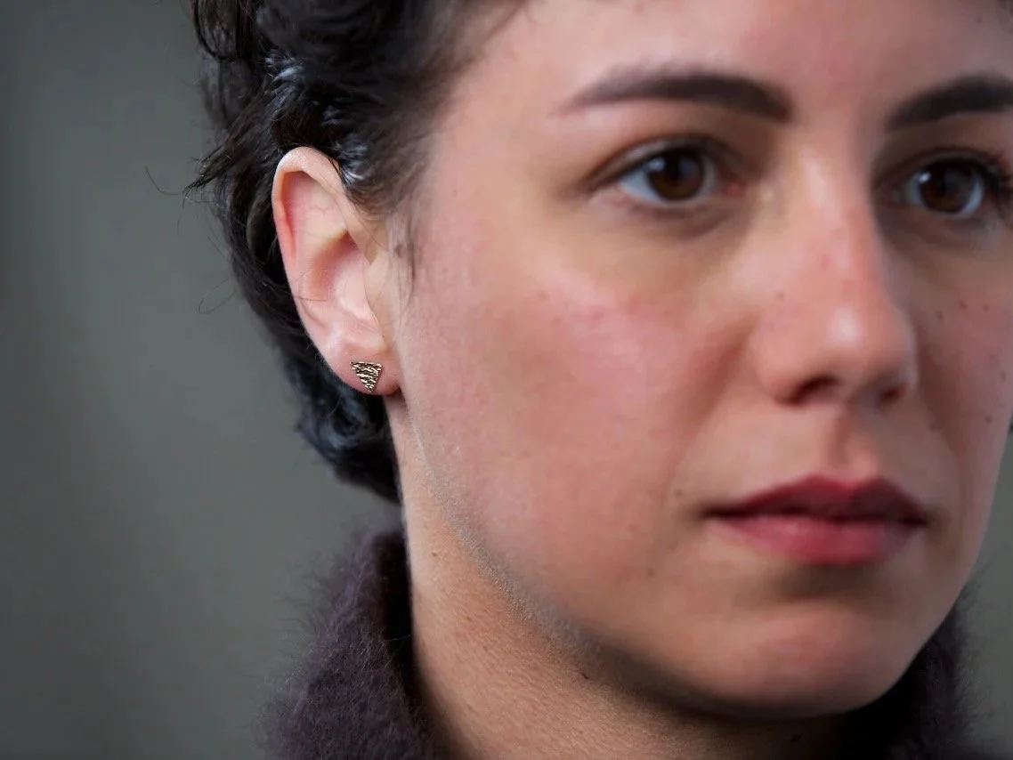 close-up-of-models-face-focusing-on-the-right-ear-wearing-triangle-stamped-stud-earrings.jpg