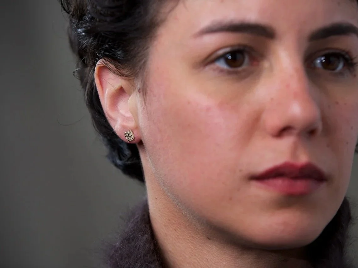 close-up-of-models-face-focusing-on-the-right-ear-wearing-square-stamped-stud-earrings.jpg