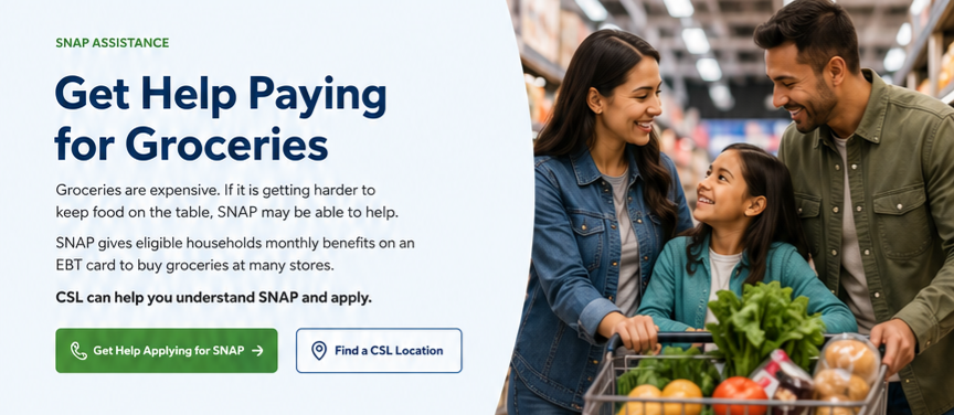A family shopping for groceries in a supermarket, smiling and looking at their shopping cart filled with vegetables and fruits.