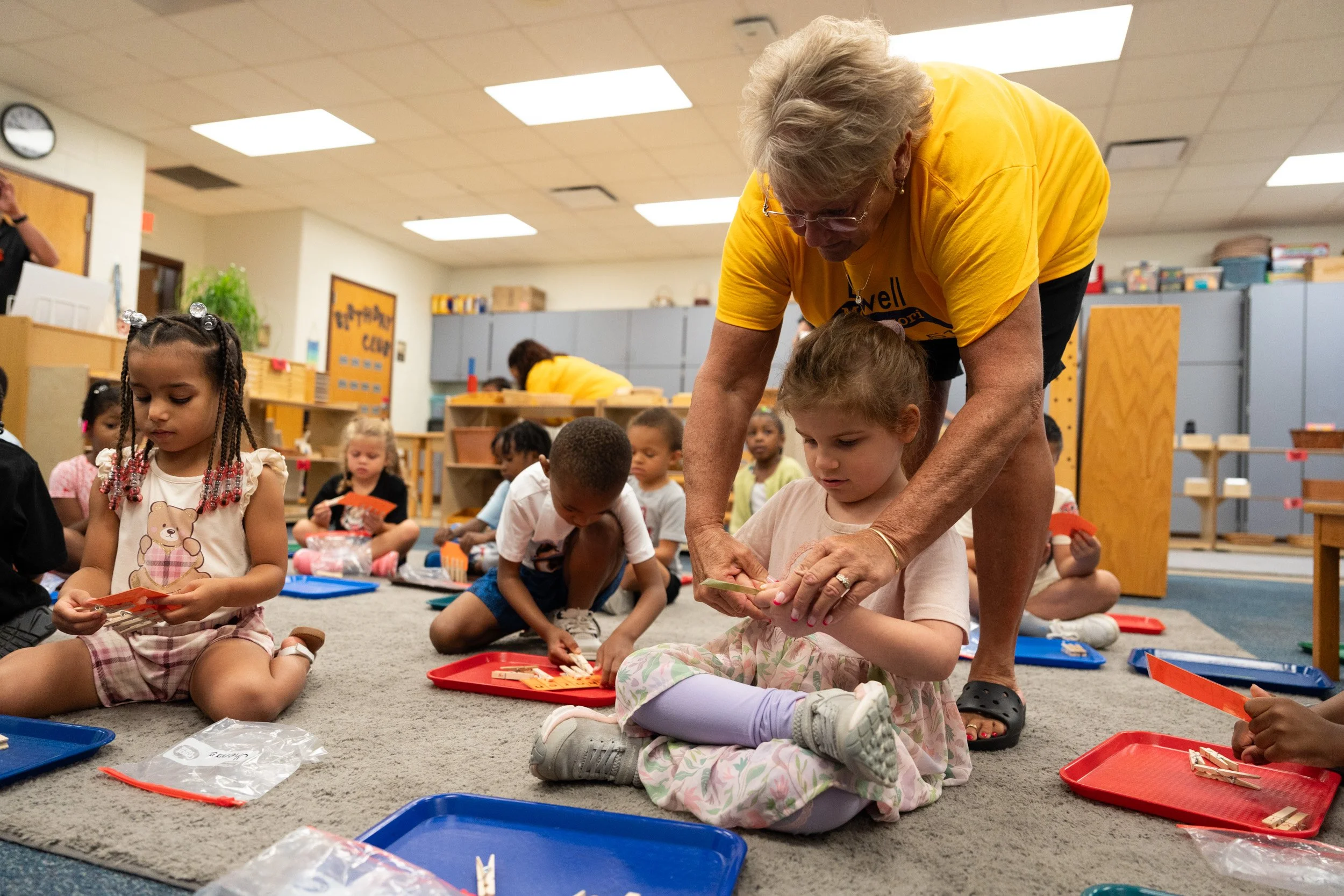 Kindergarten and pre-k teacher Mrs. Melisa Alkire helping Luna Mundy, 4, out with an activity during the first day of school on August 10, 2026 at James Russell Lowell Montessori School 51.