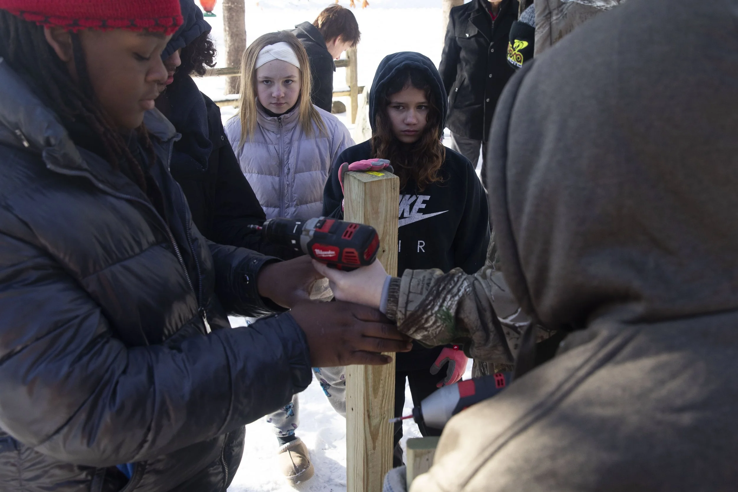 Lamans Brewer, 14, Kollin Harrell, 14 and Annie Caller, 12,  work on building a ramp for a student's father who became disabled after a crash a year ago. Mike Arbuckle, an industrial arts teacher at Concord Middle School lead the project and installm