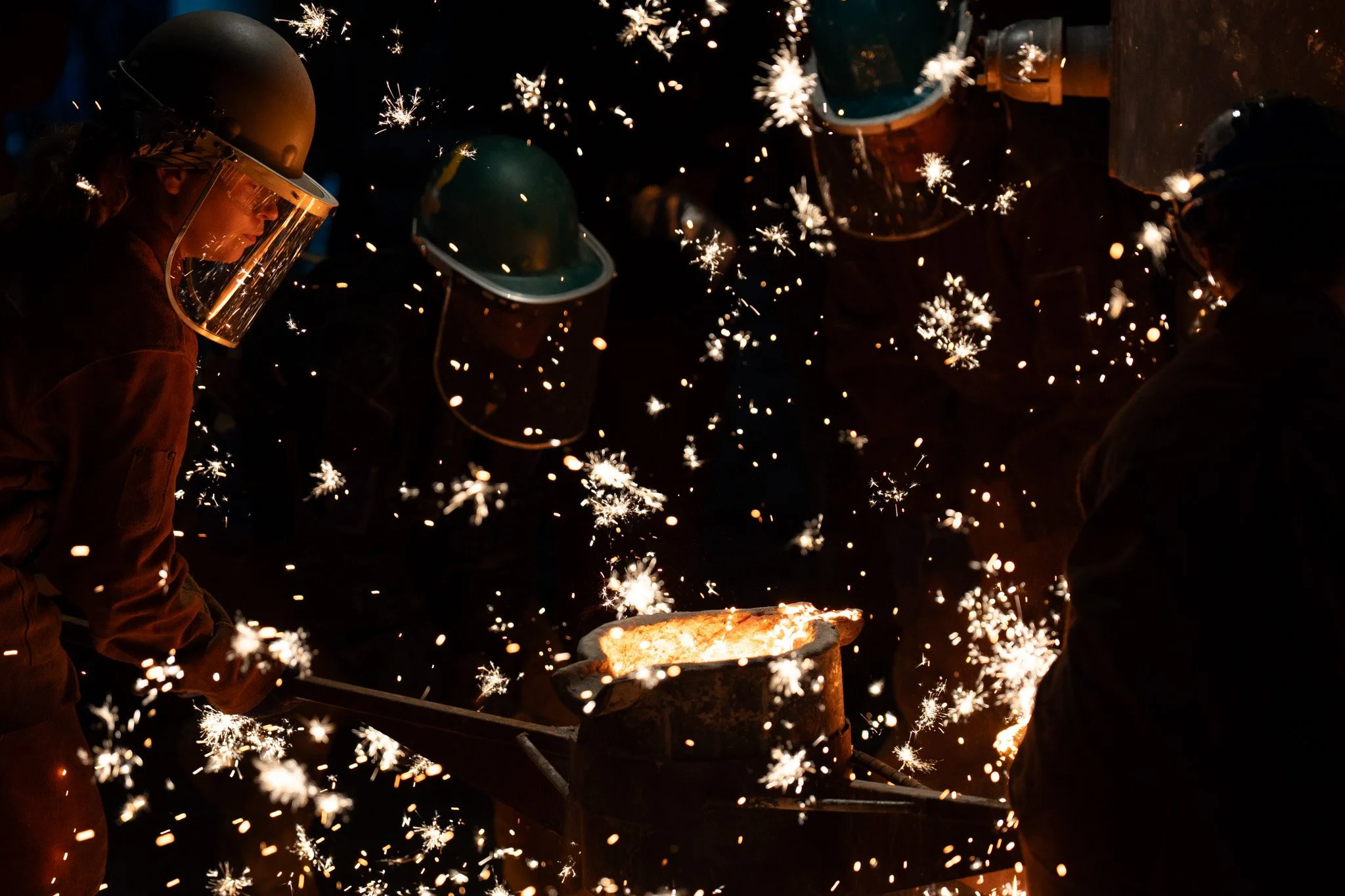 Intern metal artists pour lava to make a sculpture on July 18, 2026. About 30 interns take over the Sculpture Trails in Solesberry at night. 