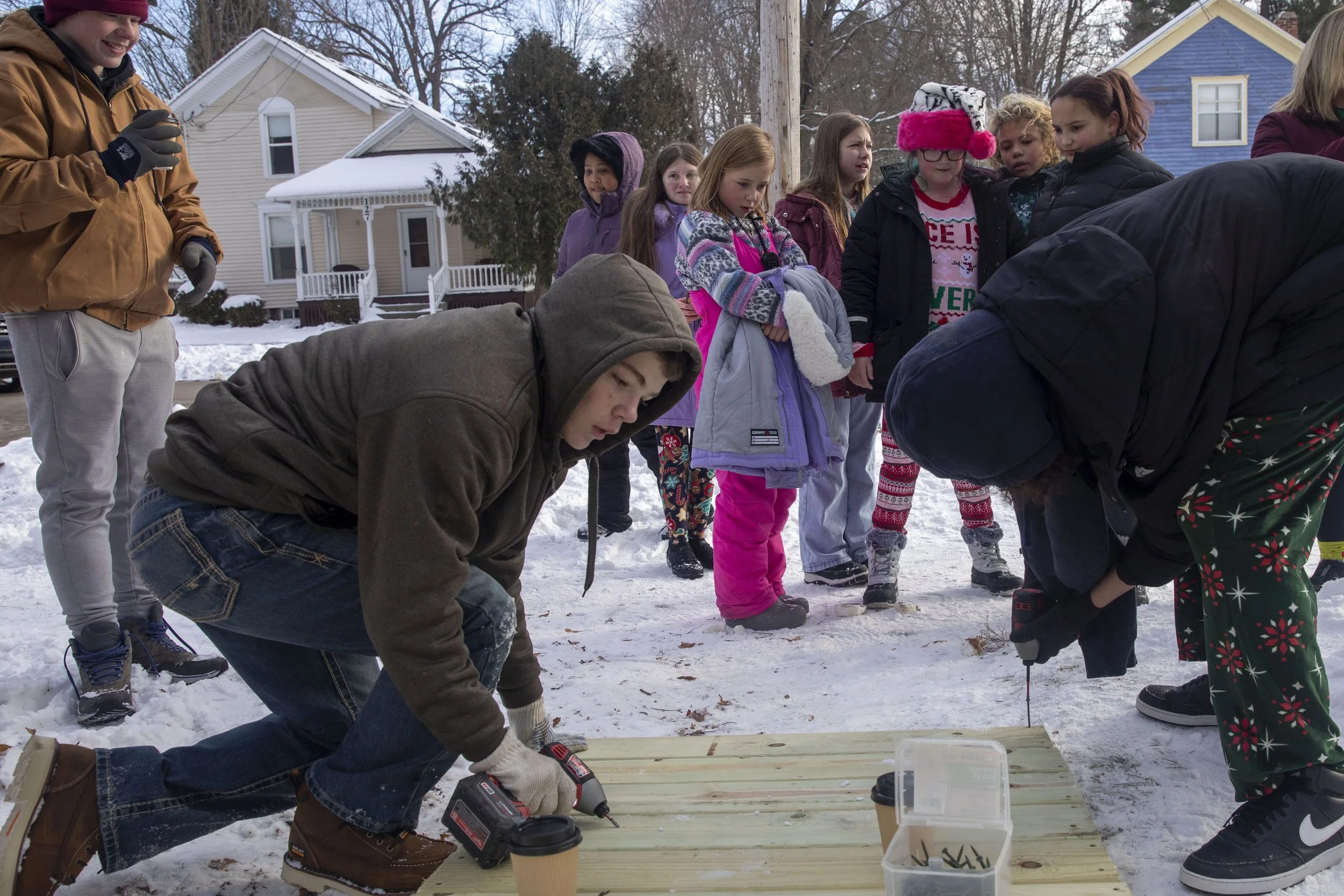 Nevaeh Steers, 10, and her class watch as Concord Middle School’s students work on building a ramp for a her father who became disabled after a crash a year ago. Mike Arbuckle, an industrial arts teacher at Concord Middle School lead the project and 