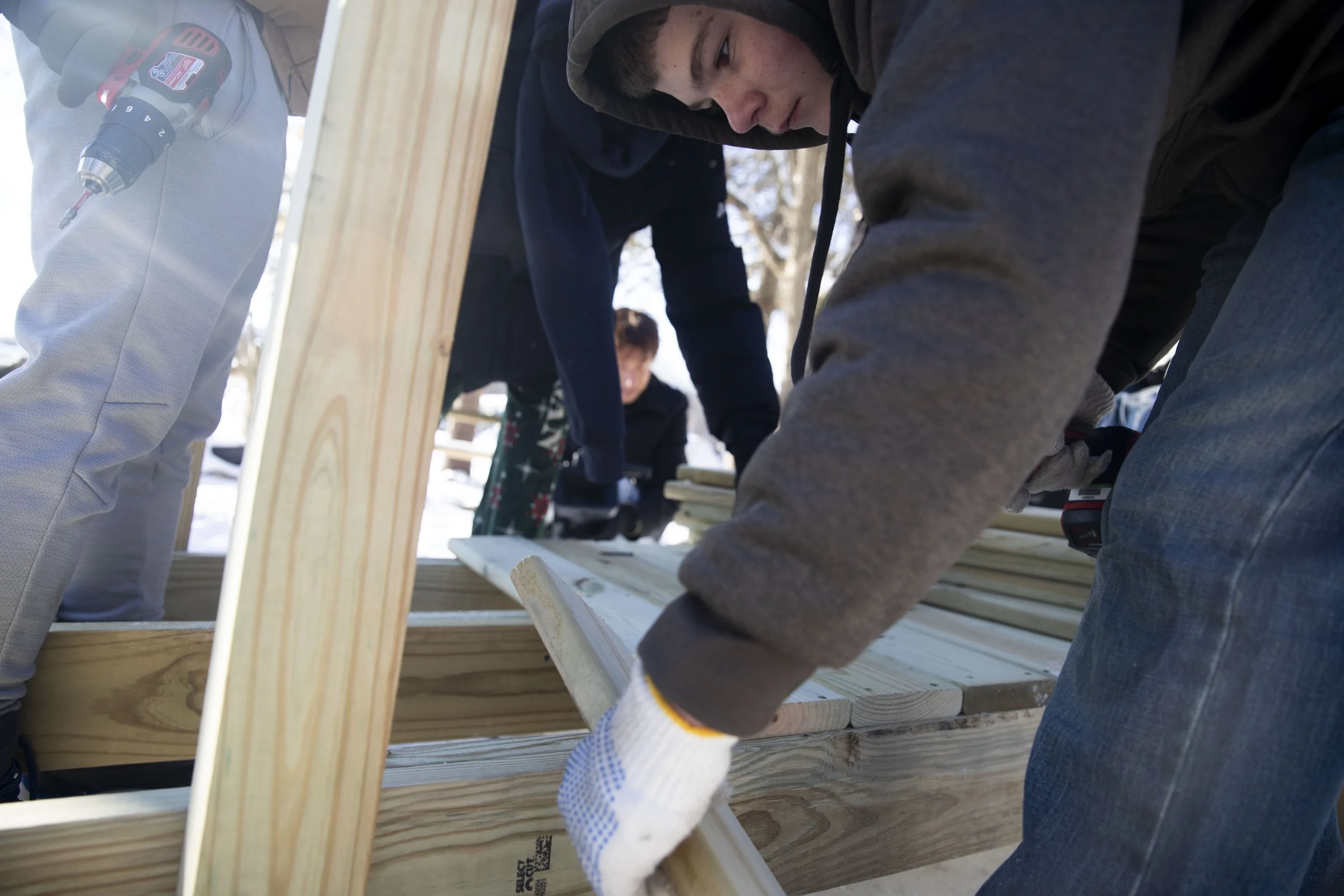 Kollin Harrell, 14, works on building a ramp for a student's father who became disabled after a crash a year ago. Mike Arbuckle, an industrial arts teacher at Concord Middle School lead the project and installment outside of the home on S. Concord St