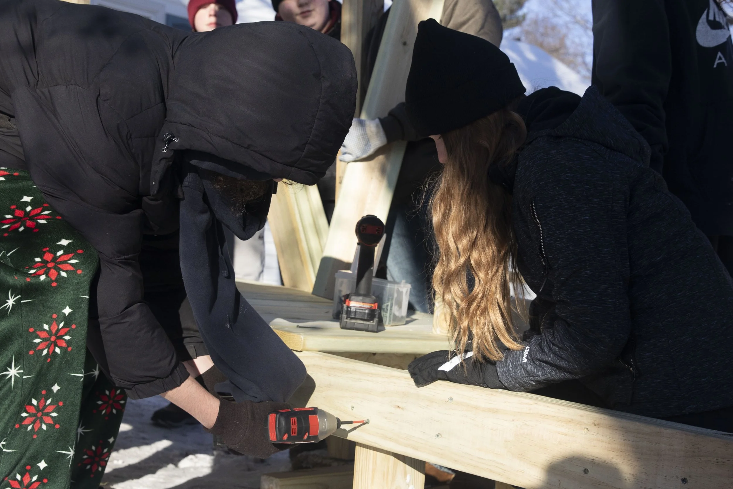 Gabriella Blanton, 14, works on building a ramp for a student's father who became disabled after a crash a year ago. Mike Arbuckle, an industrial arts teacher at Concord Middle School lead the project and installment outside of the home on S. Concord