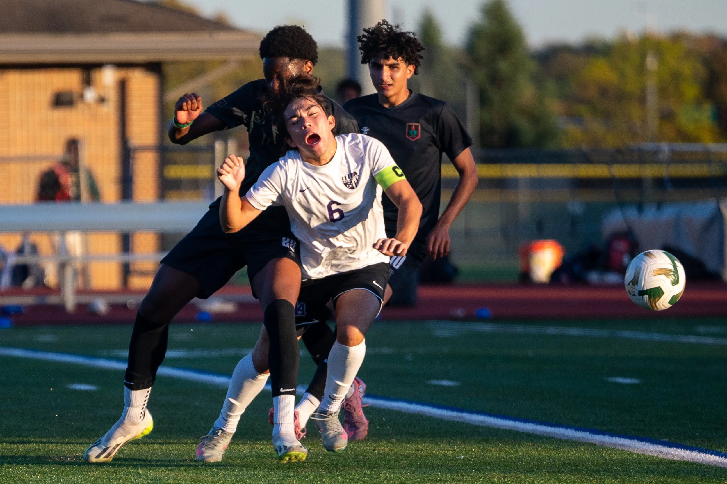 Huron High School's Amadou Sidibe (20) and Pioneer High School's Hans Lechner (6) fight for the ball during a high school soccer game at Huron High School on Thursday, Oct. 16, 2025. Huron won against Pioneer high school with a final score of 2-1.